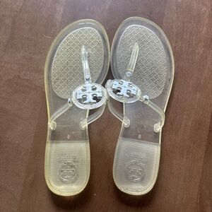 Tory Burch clear yellow sandals with white accessories.